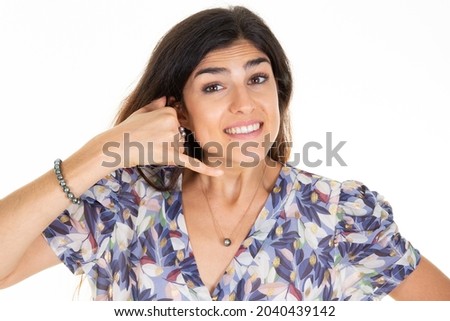 Woman brunette make phone gesture call me back with hand and fingers like talking on phone cell isolated on white background