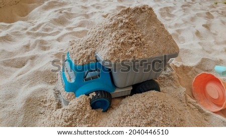 many trunks full of sand and all kinds of toys in the Children's bunker  for the joyful concept of sandpit 