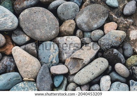 river stones, background image texture, selective focus, tinted image