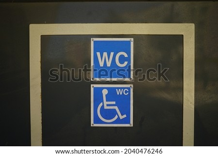 A closeup shot of a door sign for a restroom for disabled people