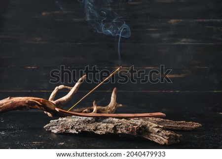 Beautiful composition with incense on dark background Royalty-Free Stock Photo #2040479933