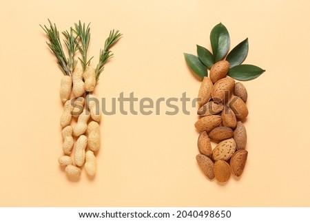 Healthy peanut and almond nuts on color background Royalty-Free Stock Photo #2040498650