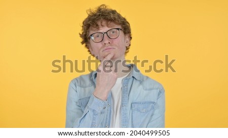 Redhead Young Man Thinking Getting Idea on Yellow Background
