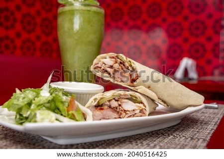 A closeup shot of wraps with sauce and juice in the cafe