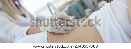 Doctor conducts ultrasound examination of patient kidneys Royalty-Free Stock Photo #2040537983