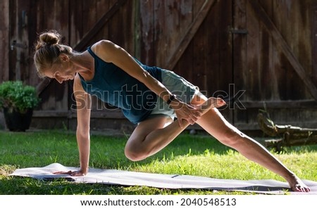 woman doing yoga outdoors in summer
