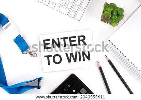 ENTER TO WIN Words on card with keyboard and office tools