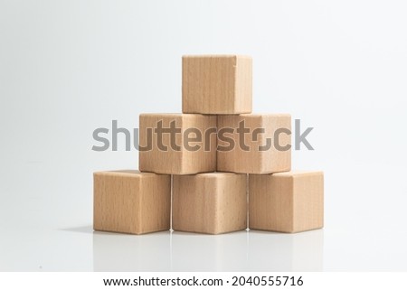 Pyramid of six wooden cubes, on white background Royalty-Free Stock Photo #2040555716