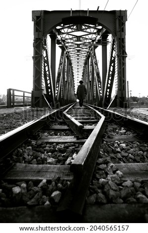 man walking in the train bridge 