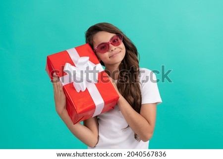 fashionable happy teen girl in sunglasses hold gift box, occasion greeting
