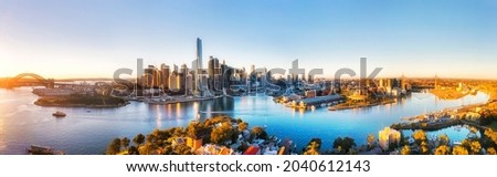 From the Sydney Harbour bridge to Anzac bridge on Sydney harbour - wide aerial panorama with city CBD in the middle. Royalty-Free Stock Photo #2040612143