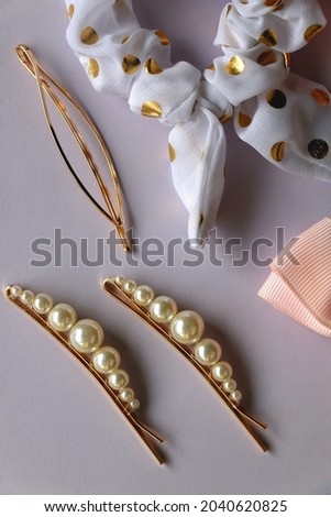 Various hair accessories in pastel and gold tones. Flat lay.