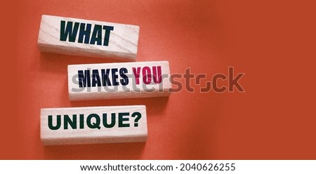What makes yiu unique - phrase on Wooden blocks. Business or carees success concept.