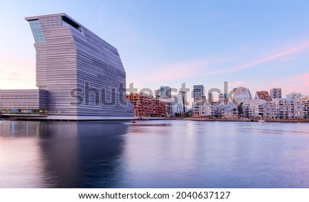 Modern buildings in Oslo, Norway, with their reflection in the water. These are some of the new buildings in the Bjorvika neighborhood. Travel and architecture concepts. Oslo - Barcode Royalty-Free Stock Photo #2040637127