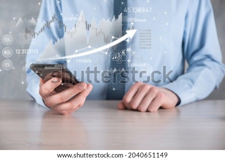Businessman hold sales data and economic growth graph chart. Business planning and strategy. Analysing trading of exchange. Financial and banking. Technology digital marketing.Profit and growing plan