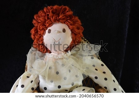 Antique Cloth Red Headed Clown Doll with Black Polka Dot Outfit on Black Background