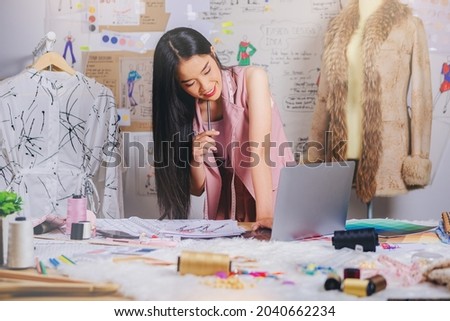 Fashion designer stylish woman working on her sketch designs in the studio.