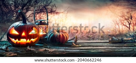 Halloween Pumpkins On Table With Spiderweb In Gloomy Landscape Royalty-Free Stock Photo #2040662246