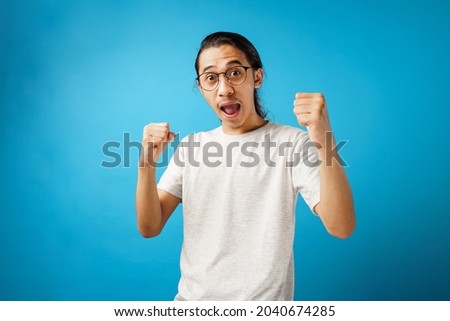 Excited screaming WOW young man in white t-shirt                               