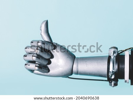 Robotic hand in retro future style in okay gesture on blue background