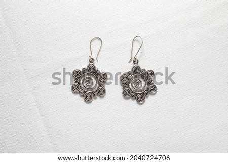 Antique real silver earring on white cloth background