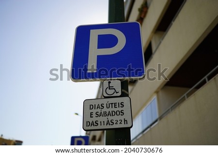 A closeup shot of a handicapped parking space sign near a building in Portugal