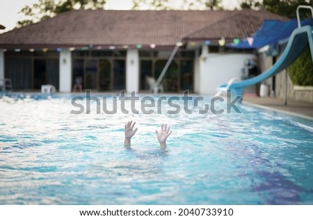 drowning child or kid and people cannot swim to deep water and raise two hands for help on swimming pool and near death with dark vignetting