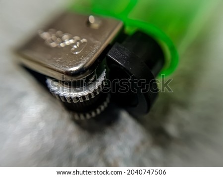 Green lighter, Green closeup lighter on blurred background 