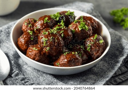 Homemade Barbecue Crockpot Meatballs in a Bowl Royalty-Free Stock Photo #2040764864