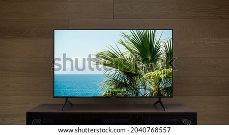 TV led mock up screen. Smart TV on a curbstone in an empty interior.  Royalty-Free Stock Photo #2040768557