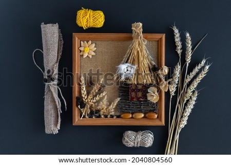 Needlework, crafts. A painting created by hand from natural materials on a dark background. Eco-creation and creativity. Horizontal photo.