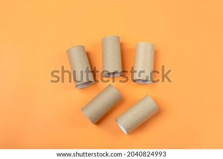 Set of bushings from toilet roll tube on orange background. DIY and kids Halloween creativity.Children Craft. Eco-friendly reuse recycle
