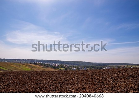 Landscapes of a plowed field outside the city in September