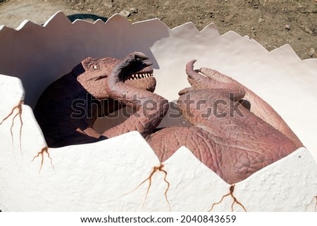 Reptile child born from egg. Reconstructed life-size animated model of a dinosaur. The largest dinosaurs DinoSofia park in Uman, Ukraine