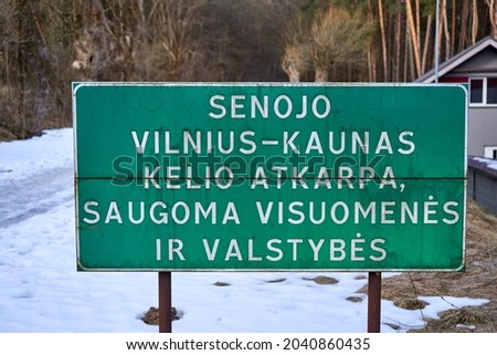 Sign of the old Vilnius - Kaunas road. Translation: Part of the old Vilnius - Kaunas road protected by people and country. 