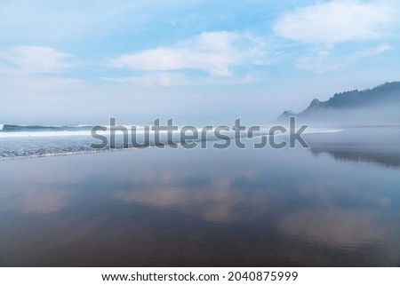 Beautiful Mirror Reflections of Sky and Clouds at an Oregon Beach