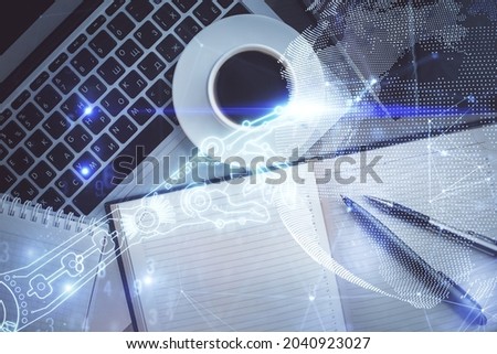 Technology hologram drawing over computer on the desktop background. Top view. Double exposure. Tech concept.