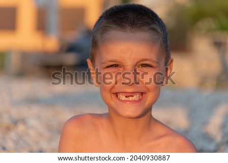 Young toothless boy at the beach
