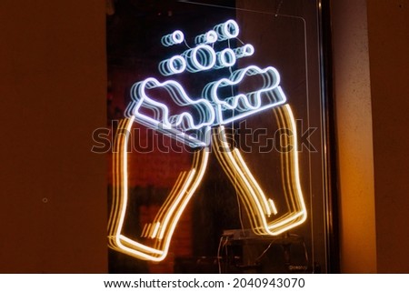  beer mug cup glasses neon sign on the window window .concept bar advertisment beer