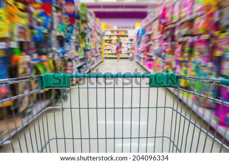 Shopping cart in toys department store Royalty-Free Stock Photo #204096334