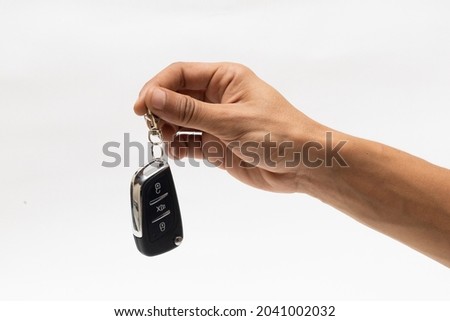 hand holding car remote isolated on white background  Royalty-Free Stock Photo #2041002032