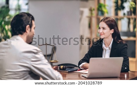 female lawyer smiles and gives legal advice to clients who come to consult