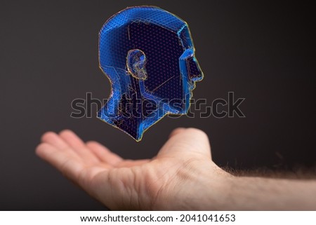 A person presenting the virtual projection of the polygonal human face - artificial intelligence concept