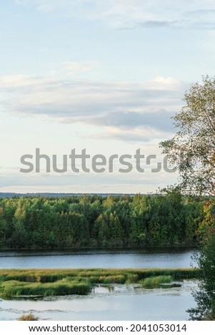 View from the cliff to the floodplain of the river at sunset, vertical photo
