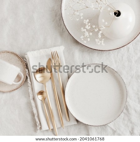 Modern ceramic tableware top view on white linen tablecloth with copy space.  Trendy plates, cutlery and linen napkins scandinavian style.Space for text or menu . Business food brand template. Royalty-Free Stock Photo #2041061768