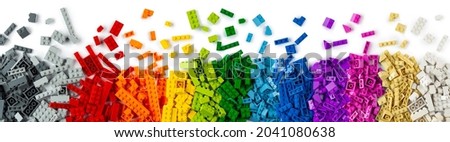 top view of wide pile various colorful rainbow colored stackable plastic toy bricks isolated on white panorama background.. childhood education construction concept Royalty-Free Stock Photo #2041080638