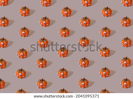 orange pumpkin pattern with eyes on a gray background, Halloween concept minimalist