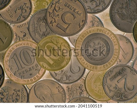 Close-up surface of many different Russian coins. Green olive tinted background or wallpaper. Backdrop on the theme of economy, finance and the central bank of Russia. Macro