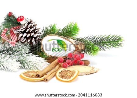 New Year and Christmas 2022, holiday decorations isolated on white background with the flag of Ecology logo engraved on a tree cut.