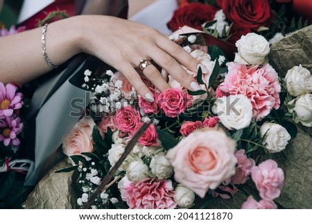 hand of the bride with a wedding ring holding a large bouquet of flowers. wedding day.